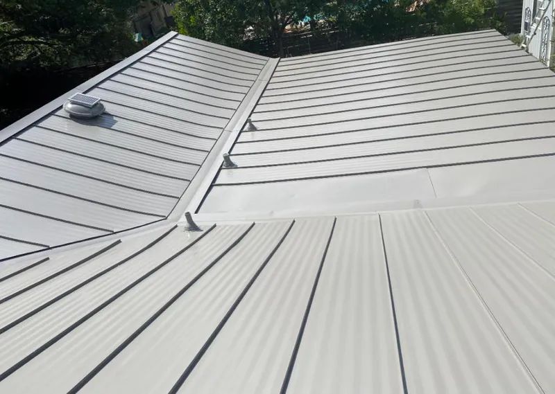 Solar attic fan installed on a metal roof for Roof Ventilation in Brentwood